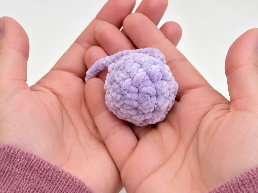 Stitch markers showing where to attach the hind legs to the crochet bunny body
